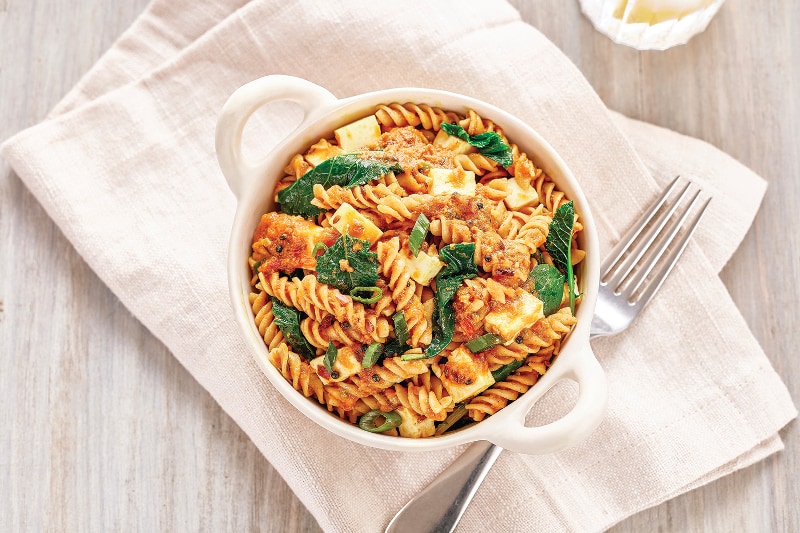 Mustard Seed Tomato Curry Fusilli with Leafy Greens and Queso Fresco